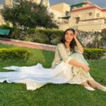 Eisha Singh Instagram - Secret conversations between the trees and sky, hums a tune of peace in my heart.🌻 . . . Adding green to my garden in this beautiful outfit by @roze.india ♥️ Juttis: @saya.india