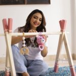 Pooja Banerjee Instagram - Hey husband @sandeepsejwal , @sanassejwaal is gonna have a lot of fun and is also going to be inspired looking at all your achievements while playing in her play gym area . Swipe to the end & watch me tie the beautiful crochet crib you from @the_original_knit #DadLife #MomLife #NewDad #NewMom #BabyLove #BabyGirl #SanaSSejwaal #SandeepSejwal #PoojaBanerjee 📸- @jerry__creations Thank you @thedotdiary for setting all this up for me ❤️🧿