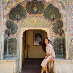 Ruhi Chaturvedi Instagram - Being a tourist ☺ . . . Peacock gate-It is one of the most famous and admired gates of them all. This gate is dedicated to Lord Vishnu and symbolizes the autumn season. It is located on the North-East side of the courtyard. The carved peacocks surround the statue of God and are brilliantly decorated with colourful paintings. . . Outfit - @vasvi_jaipur . . #iwannatraveltheworld #jaipurdiaries #citypalace City Palace, Jaipur