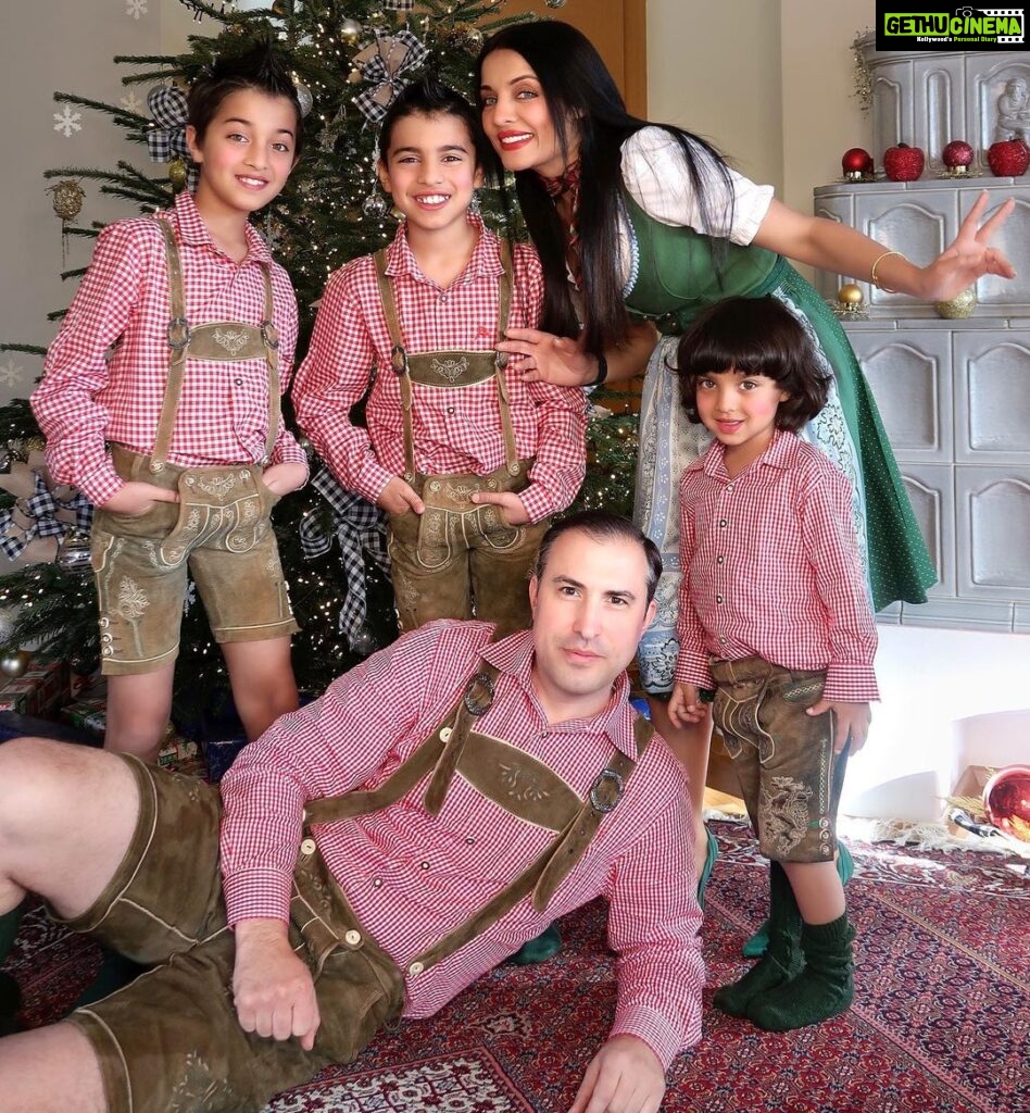 Celina Jaitly Instagram - Getting this huge half Austrian half Indian family to fit and pose in front of our Christmas tree ( without calling emergency services) deserves a Nobel prize in patience for @haag.peter and my self 😂. Don't worry, it's just the first 40 years of parenting that are the hardest. Having said that.. I count my Christmas blessings with my family's faces…. Hope you had a delicious Christmas… 🧿 Ps - If you are wondering what we are wearing well it is our Austrian National dress the lederhosen for the boys and Dirndl for me. #🧿 #family #european #austrian #indian #celina #celinajaitly #celinajaitley #peterhaag #winstonjhaag #viraajhaag #arthurjhaag #eurasian #bollywood #indianactress #weihnachten #christmastree #dirndl #lederhosen #christmas #christmasoutfit #familyphotography #familyphotos Austria, Europe