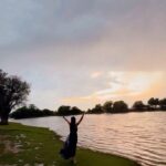 Krystle D'Souza Instagram - Unexpected drizzle by the lake at sunset was the icing on the cake 🥂 . . . #everydarkcloudhasasilverlining This Lake is a half an hour drive from @narendra.bhawan.bikaner where they organised such a beautiful sunset setup ✨ #Lake #Travel #incredibleindia #lakeside #sunset #champagne #dancingintherain #rain #bikaner #narendrabhawan #palace #holi #trip #greyskies Narender Bhavan, Bikaner