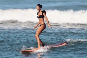 Lisa Haydon Instagram - Have always been scared to surf in Bali.. the waves seem huge and verryyyyy professional. The other day I was surfing a big foam board, so scared after not being in open ocean surfing like this in three years, and sooo rusty. Basically spent the morning in “the laundry” as our teacher Nyoman puts it. Haha, if you know you know 🫣. But as my husband quite rightly says “don’t waste a day in Bali” … in other words, if you don’t get out there, you didn’t live it to the fullest. Second slide has a wee little friend 🐢 that popped his head up a few times this morning 🫶🏽🫶🏽🫶🏽 If you’re ever in Bali head to Batu Balong for some sweet baby waves and ask for Nyoman who will push you onto the wave🙃enjoyyyyy #BaliHai #BaliHigh @lareveche