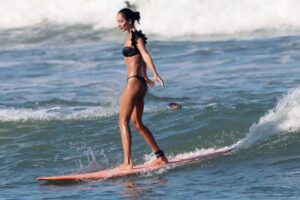 Lisa Haydon Instagram - Have always been scared to surf in Bali.. the waves seem huge and verryyyyy professional. The other day I was surfing a big foam board, so scared after not being in open ocean surfing like this in three years, and sooo rusty. Basically spent the morning in “the laundry” as our teacher Nyoman puts it. Haha, if you know you know 🫣. But as my husband quite rightly says “don’t waste a day in Bali” … in other words, if you don’t get out there, you didn’t live it to the fullest. Second slide has a wee little friend 🐢 that popped his head up a few times this morning 🫶🏽🫶🏽🫶🏽 If you’re ever in Bali head to Batu Balong for some sweet baby waves and ask for Nyoman who will push you onto the wave🙃enjoyyyyy 
#BaliHai #BaliHigh 
@lareveche