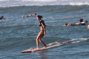 Lisa Haydon Instagram - Have always been scared to surf in Bali.. the waves seem huge and verryyyyy professional. The other day I was surfing a big foam board, so scared after not being in open ocean surfing like this in three years, and sooo rusty. Basically spent the morning in “the laundry” as our teacher Nyoman puts it. Haha, if you know you know 🫣. But as my husband quite rightly says “don’t waste a day in Bali” … in other words, if you don’t get out there, you didn’t live it to the fullest. Second slide has a wee little friend 🐢 that popped his head up a few times this morning 🫶🏽🫶🏽🫶🏽 If you’re ever in Bali head to Batu Balong for some sweet baby waves and ask for Nyoman who will push you onto the wave🙃enjoyyyyy 
#BaliHai #BaliHigh 
@lareveche