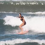 Lisa Haydon Instagram - Have always been scared to surf in Bali.. the waves seem huge and verryyyyy professional. The other day I was surfing a big foam board, so scared after not being in open ocean surfing like this in three years, and sooo rusty. Basically spent the morning in “the laundry” as our teacher Nyoman puts it. Haha, if you know you know 🫣. But as my husband quite rightly says “don’t waste a day in Bali” … in other words, if you don’t get out there, you didn’t live it to the fullest. Second slide has a wee little friend 🐢 that popped his head up a few times this morning 🫶🏽🫶🏽🫶🏽 If you’re ever in Bali head to Batu Balong for some sweet baby waves and ask for Nyoman who will push you onto the wave🙃enjoyyyyy #BaliHai #BaliHigh @lareveche