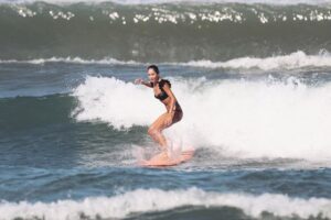 Lisa Haydon Instagram - Have always been scared to surf in Bali.. the waves seem huge and verryyyyy professional. The other day I was surfing a big foam board, so scared after not being in open ocean surfing like this in three years, and sooo rusty. Basically spent the morning in “the laundry” as our teacher Nyoman puts it. Haha, if you know you know 🫣. But as my husband quite rightly says “don’t waste a day in Bali” … in other words, if you don’t get out there, you didn’t live it to the fullest. Second slide has a wee little friend 🐢 that popped his head up a few times this morning 🫶🏽🫶🏽🫶🏽 If you’re ever in Bali head to Batu Balong for some sweet baby waves and ask for Nyoman who will push you onto the wave🙃enjoyyyyy 
#BaliHai #BaliHigh 
@lareveche