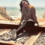Samvrutha Sunil Instagram - I am sitting on an ancient, broken railway track. Please do not try the same on a railway track in use😊.