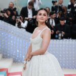 Alia Bhatt Instagram - Met Gala — Karl Lagerfeld: A Line of Beauty I have always been fascinated by the iconic Chanel brides. Season after season, the genius of Karl Lagerfeld shone through in the most innovative and awe-inspiring couture. My look tonight was inspired from this and in particular by supermodel Claudia Schiffer’s 1992 Chanel bridal look. I wanted to do something that felt authentic (hello, pearls!) and proudly made in India. The embroidery, made with a 100,000 pearls is a labour of love by @prabalgurung. I’m so proud to wear you for my first Met. Make up was my go to beautiful glowing sheer skin but this time with wayyyyyyyy more blush to give the look all that romance, rounding it off with a smudgy defined eye with Kajal one the inside (our subtle ode to Karl’s sunglasses 🕶️) A girl can never have too many pearls… and the right accessories to complement the look which in our case translated to the bow of pearls on my hair. Oh, and it’s white, for my Choup-ED🐱
