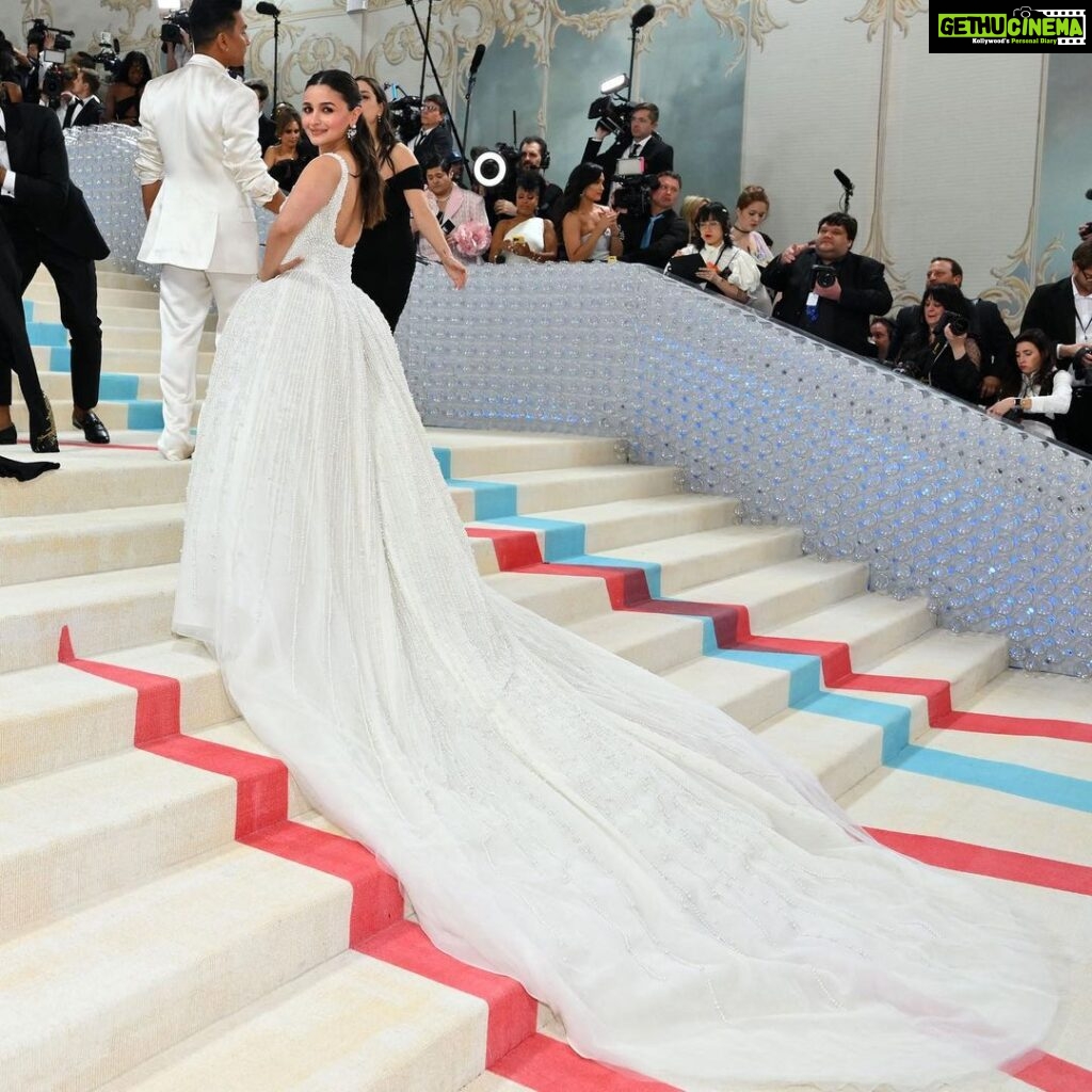 Alia Bhatt Instagram - Met Gala — Karl Lagerfeld: A Line of Beauty I have always been fascinated by the iconic Chanel brides. Season after season, the genius of Karl Lagerfeld shone through in the most innovative and awe-inspiring couture. My look tonight was inspired from this and in particular by supermodel Claudia Schiffer’s 1992 Chanel bridal look. I wanted to do something that felt authentic (hello, pearls!) and proudly made in India. The embroidery, made with a 100,000 pearls is a labour of love by @prabalgurung. I’m so proud to wear you for my first Met. Make up was my go to beautiful glowing sheer skin but this time with wayyyyyyyy more blush to give the look all that romance, rounding it off with a smudgy defined eye with Kajal one the inside (our subtle ode to Karl’s sunglasses 🕶️) A girl can never have too many pearls… and the right accessories to complement the look which in our case translated to the bow of pearls on my hair. Oh, and it’s white, for my Choup-ED🐱