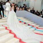 Alia Bhatt Instagram - Met Gala — Karl Lagerfeld: A Line of Beauty I have always been fascinated by the iconic Chanel brides. Season after season, the genius of Karl Lagerfeld shone through in the most innovative and awe-inspiring couture. My look tonight was inspired from this and in particular by supermodel Claudia Schiffer’s 1992 Chanel bridal look. I wanted to do something that felt authentic (hello, pearls!) and proudly made in India. The embroidery, made with a 100,000 pearls is a labour of love by @prabalgurung. I’m so proud to wear you for my first Met. Make up was my go to beautiful glowing sheer skin but this time with wayyyyyyyy more blush to give the look all that romance, rounding it off with a smudgy defined eye with Kajal one the inside (our subtle ode to Karl’s sunglasses 🕶️) A girl can never have too many pearls… and the right accessories to complement the look which in our case translated to the bow of pearls on my hair. Oh, and it’s white, for my Choup-ED🐱