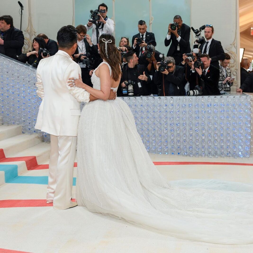 Alia Bhatt Instagram - Met Gala — Karl Lagerfeld: A Line of Beauty I have always been fascinated by the iconic Chanel brides. Season after season, the genius of Karl Lagerfeld shone through in the most innovative and awe-inspiring couture. My look tonight was inspired from this and in particular by supermodel Claudia Schiffer’s 1992 Chanel bridal look. I wanted to do something that felt authentic (hello, pearls!) and proudly made in India. The embroidery, made with a 100,000 pearls is a labour of love by @prabalgurung. I’m so proud to wear you for my first Met. Make up was my go to beautiful glowing sheer skin but this time with wayyyyyyyy more blush to give the look all that romance, rounding it off with a smudgy defined eye with Kajal one the inside (our subtle ode to Karl’s sunglasses 🕶️) A girl can never have too many pearls… and the right accessories to complement the look which in our case translated to the bow of pearls on my hair. Oh, and it’s white, for my Choup-ED🐱