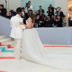 Alia Bhatt Instagram - Met Gala — Karl Lagerfeld: A Line of Beauty I have always been fascinated by the iconic Chanel brides. Season after season, the genius of Karl Lagerfeld shone through in the most innovative and awe-inspiring couture. My look tonight was inspired from this and in particular by supermodel Claudia Schiffer’s 1992 Chanel bridal look. I wanted to do something that felt authentic (hello, pearls!) and proudly made in India. The embroidery, made with a 100,000 pearls is a labour of love by @prabalgurung. I’m so proud to wear you for my first Met. Make up was my go to beautiful glowing sheer skin but this time with wayyyyyyyy more blush to give the look all that romance, rounding it off with a smudgy defined eye with Kajal one the inside (our subtle ode to Karl’s sunglasses 🕶️) A girl can never have too many pearls… and the right accessories to complement the look which in our case translated to the bow of pearls on my hair. Oh, and it’s white, for my Choup-ED🐱