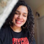 Ann Augustine Instagram - That Feeling good bout myself ‘PSYCHO-tee’ smile! #psycho#favourite#psychotee#curls#curlyhair#jewelleryaddict#goodhairday#silverlove#coffeelover#staysafe#beachlover#home#favtees#feelinggood#artlover