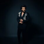 Arjun Kapoor Instagram – Spent last evening in my very own custom made double breasted black suit by the very special @anamikakhanna.in ♥️

Loved the exhibit at #NMACC, it truly represented our culture & the evolution of the landscape of fashion inspired by india 🇮🇳 kudos to the Ambani family & @rooshadshroff for giving us something so unique! 🙌
@nmacc.india

Photographer: @bharat_rawail
Stylist: @rahulvijay1988 

Assisted by: @maitriidesaii @sabrinawhite98 @nirikshapoojary_
Jewellery: @amrapalijewels 

Hair: @aalimhakim
@bashirsayyed.hair
Make-up: @vickybanatkar