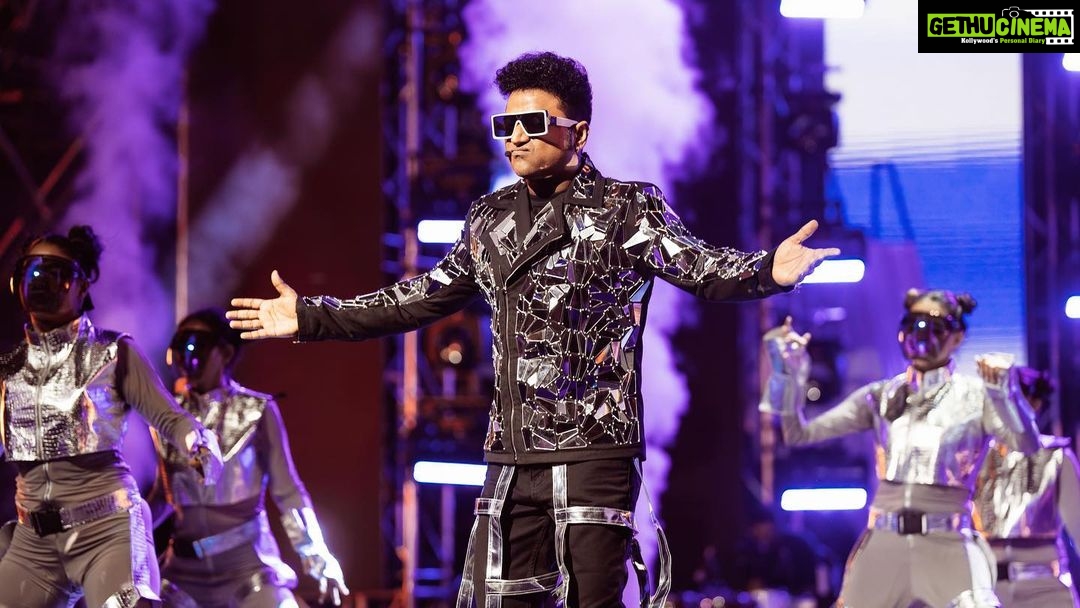 Devi Sri Prasad Instagram - ✨ Witnessing the magnificence of DSP's entry at the concert was an absolute game-changer! 🌟✨ From the moment he stepped on that stage, it was clear that this man knows how to make an entrance like no other. The air was charged with anticipation as the crowd erupted in thunderous applause, and the energy in the room soared to new heights. DSP's presence was electrifying, his charisma captivating, and his passion for music contagious. The atmosphere was nothing short of pure magic as he set the stage on fire with his mesmerizing talent. It was a moment that will forever be etched in our hearts. 🎶❤️ #DSPConcert #EntranceMaster #musicalmagic #oosolriyaoooosolriya Bukit Jalil National Stadium