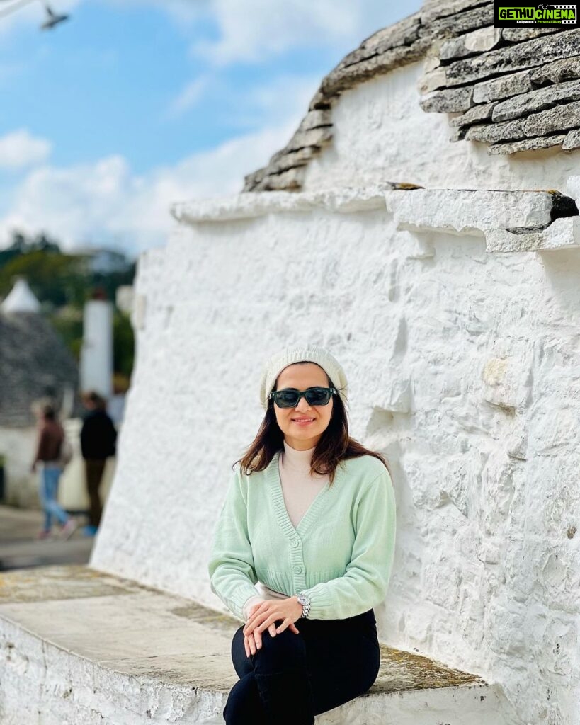 Dhivyadharshini Instagram - The beauty of alberobello town (Italy) is mesmerising This town is easily more than 500 hundred years old and the trulli (the type of house you see remains untouched and well preserved with stone structures that have no cement between them) it’s a unesco world heritage site @gtholidays.in and I wanted to show you the less explored locales of every country in our holidays 😉 Go to my stories to see more of it ❤️ #ddholidays #gtholidays #ddneelakandan #travel #italy #alberobello #trulli #holiday #tourism @italyexplores Trulli di Alberobello