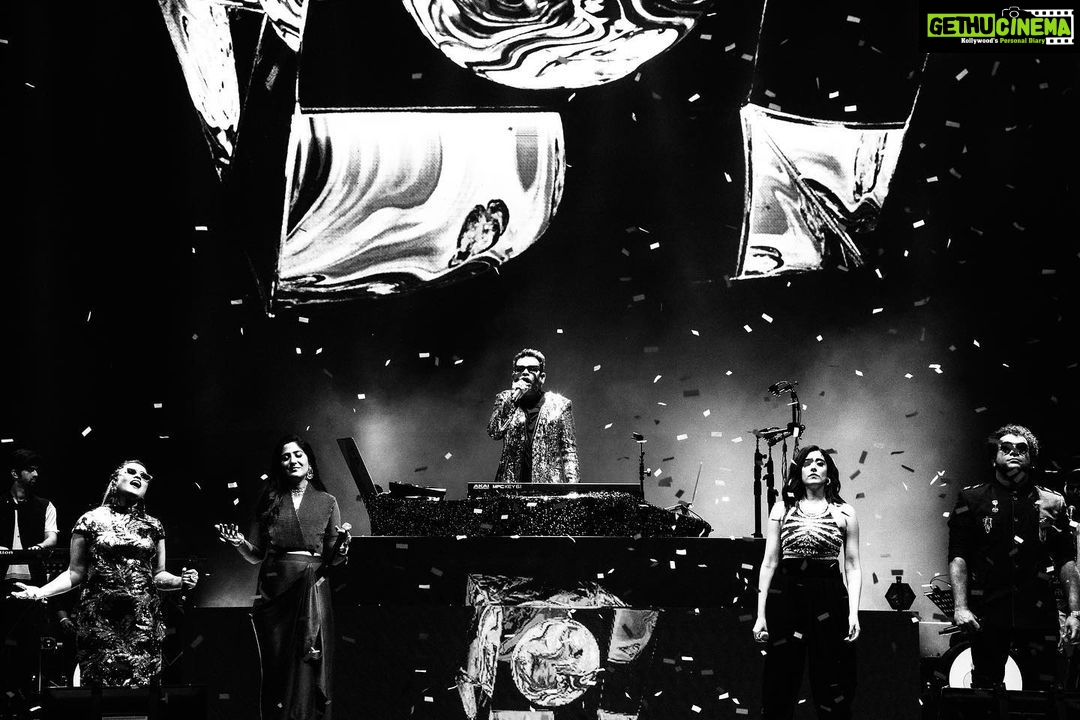Haricharan Instagram - These are some amazing Pictures by @vengka_desh at the Recent concert in Kuala Lumpur with ARR sir. Always an Honour! Icing on the cake was sharing the stage with the super cute @ctdk , indeed an experience to Perform ‘Munbe Vaa’ with her. Grooving and Vibing with my Buddies on stage with another 72,000 of you malaysia. Etched in my Mind #dmy #arrahman #malaysia #haricharan