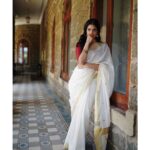 Malavika Mohanan Instagram - Happy Vishu everyone ✨♥️ It’s that one day in the year where I get to wear a traditional ‘kasavu’ saree without it feeling out of context, and maybe because I hardly get to do it is why I sway in the direction of always donning a classic one and nothing too sartorially adventurous. I wear it with jewelry strictly borrowed from mom’s closet because she has the most beautiful gold jhumkis & traditional temple jewelry, and ours seems to be the generation that has a general disdain for accumulation of gold jewelry(or is it just me?) Anyway, I digress. So coming back to Vishu and all things malayali, here are some pictures of me in a lovely palace estate in Kerala with the most beautiful corridors & the most stunning old trees which feeds right into my nostalgia trip of my malayali roots & strangely makes me feel at home even though it’s the first time I’ve visited this place. Ok. Time for some payasam now. So talk to you’ll soon and hope you had your fill of ‘sadhya’ today too ☺️♥️ P.S photos by the amazing @sbk_shuhaib & everything everywhere in life is pretty much courtesy @theitembomb