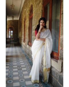 Malavika Mohanan Instagram - Happy Vishu everyone ✨♥️

It’s that one day in the year where I get to wear a traditional ‘kasavu’ saree without it feeling out of context, and maybe because I hardly get to do it is why I sway in the direction of always donning a classic one and nothing too sartorially adventurous. I wear it with jewelry strictly borrowed from mom’s closet because she has the most beautiful gold jhumkis & traditional temple jewelry, and ours seems to be the generation that has a general disdain for accumulation of gold jewelry(or is it just me?) Anyway, I digress. So coming back to Vishu and all things malayali, here are some pictures of me in a lovely palace estate in Kerala with the most beautiful corridors & the most stunning old trees which feeds right into my nostalgia trip of my malayali roots & strangely makes me feel at home even though it’s the first time I’ve visited this place. 
Ok. Time for some payasam now. So talk to you’ll soon and hope you had your fill of ‘sadhya’ today too ☺️♥️

P.S photos by the amazing @sbk_shuhaib & everything everywhere in life is pretty much courtesy @theitembomb