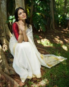 Malavika Mohanan Instagram - Happy Vishu everyone ✨♥️

It’s that one day in the year where I get to wear a traditional ‘kasavu’ saree without it feeling out of context, and maybe because I hardly get to do it is why I sway in the direction of always donning a classic one and nothing too sartorially adventurous. I wear it with jewelry strictly borrowed from mom’s closet because she has the most beautiful gold jhumkis & traditional temple jewelry, and ours seems to be the generation that has a general disdain for accumulation of gold jewelry(or is it just me?) Anyway, I digress. So coming back to Vishu and all things malayali, here are some pictures of me in a lovely palace estate in Kerala with the most beautiful corridors & the most stunning old trees which feeds right into my nostalgia trip of my malayali roots & strangely makes me feel at home even though it’s the first time I’ve visited this place. 
Ok. Time for some payasam now. So talk to you’ll soon and hope you had your fill of ‘sadhya’ today too ☺️♥️

P.S photos by the amazing @sbk_shuhaib & everything everywhere in life is pretty much courtesy @theitembomb