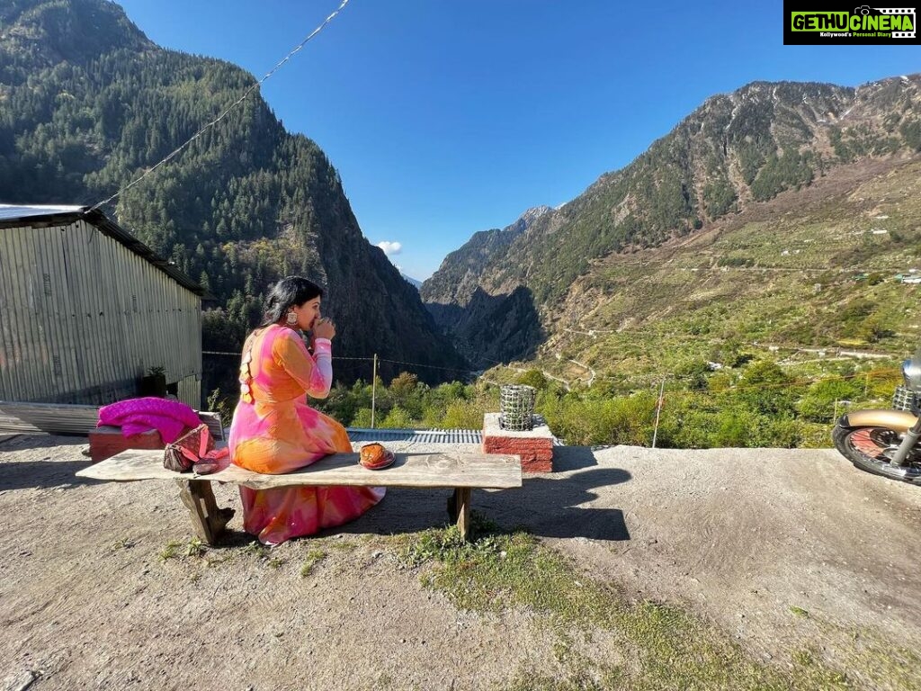 Nandini Rai Instagram - My view is perfect with a cup of tea and the mountains touching the blue sky ..! #mountains #fyp #bench #sweaterweather #tea Harshil valley - mini Switzerland
