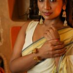 Navya Nair Instagram - "Adorned in this enchanting traditional saree with golden glowing tapestry, I find myself immersed in divine elegance ✨🌟 A sublime fusion of heritage and grace, this ethereal attire weaves a tale of celestial beauty, illuminating my very soul 💫🥰 Let's celebrate our radiant roots and light up the world together, my lovely Insta-fam 🌍💛 #SareeLove #GoldenGlow #DivineElegance #CherishingTraditions" Makeup @makeupby_nami_ Styling @sabarinathk_ Wearing @kasavukada_1985 Photography @nithin_c_nandakumar