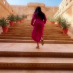 Navya Nair Instagram - In the golden heart of Jaisalmer, I tread, Where ancient whispers echo, time's tapestry spread. Each step a dance with history's grace, A palace of dreams, in this desert embrace. Sun-kissed walls, the stories they've seen, Of love and loss, of kings and queens. I wander in awe, this regal maze, A timeless beauty, my soul ablaze. Rajasthan's jewel, a realm so rare, In every corner, magic in the air. As I leave, forever changed, I see, The palace within, a reflection of me. ✨🕌💫 #JaisalmerDreams #TimelessWanderer @suryagarh Shots @amal_ajithkumar Edits @4rshuuu