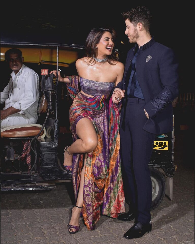 Priyanka Chopra Instagram - Date night and a 🛺….. with my forever guy @nickjonas Thank you @stylebyami as always for your amazing collaboration. I knew I wanted to wear an upcycled vintage look with a modern twist! So my outfit was an amalgamation of the east and the west! Like me! Thank you @amitaggarwalofficial for coming through and creating this handcrafted beauty with a story that is so apt for an evening celebrating Indian art and Fashion. This beautiful outfit was created using a 65 year old vintage Banarasi patola (Brocade)saree with silver threads and a gold electroplating on khadi silk. It is paired with a sequins sheet holographic bustier to reflect the nine colours of ikat weave that the brocade is set in. Thank you for your genius Amit and your gifted team. Congratulations #NitaAmbani and @_iiishmagish for creating an incredible exhibition of the history Indian fashion at the @nmacc.india! So proud of this exquisite space and the potential it has to promote Indian Art and design ❤️ Ps- Also for all wondering auto uncle took the cake! Was lovely and gracious! Thank you auto uncle! Mumbai, Maharashtra