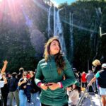 Aarti Chhabria Instagram - “Anything can make me stop and look and wonder, and sometimes learn.” —Kurt Vonnegut #quotes #goodmorning #milfordsound #aartichabria #greenjacket #waterfall #glare #sun Milford Sound, Fiordland National Park