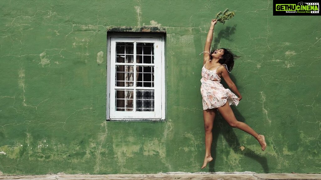 Amala Paul Instagram - Flowers of joy bloom in her hands as she jumps towards a world painted in green and filled with endless adventures. 🌿🌸 Captured by @chathan__ #lightscameraaction #travelgram #wanderlust #exploremore #mountainlife #instanature #travelphotography #hikingadventures #exploretheworld #mountainlover #forestvibes