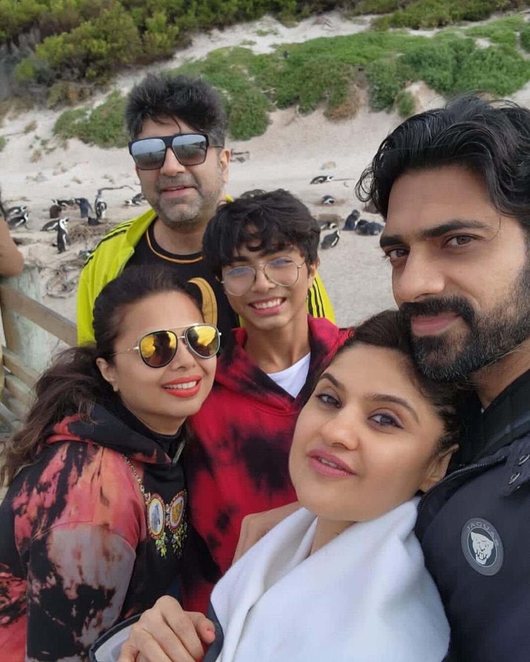 Archana Instagram - Day 02 #capetownsouthafrica On our day tour visited the #penguin colony at Boulders Beach & loved the way no one hushed whistled or bullied the animals by any notice or action … penguins are very private creatures and just love to chill with their tribe … delight to visit their nesting holes by the beach & see them snuggle and huddle with their loved ones … like my tribe is as huddling for pictures with them :D Don’t miss the #possum sneakily looking towards me in the bushes 🫣🙈🤪 . . . #love #naturephotography #wildlife #beach #travel Boulders Beach Penguin Colony