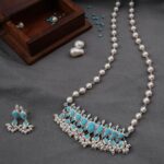 Girija Oak Instagram - A classic & graceful in-house Turquoise Stone Tanmani set with a combination of Freshwater pearls. A classic & authentic piece of jewellery with matching earrings. This gorgeous piece is perfect for the festive season!! Shop online and in-stores. www.aadyaa.com For queries please WhatsApp us at 7219275608 #tanmani #turquoisejewelry #statementjewelry #silvernecklace #aadyaa #handcrafted #silver925 #preciousstones Aadyaa