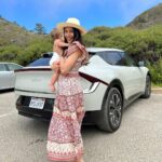 Freida Pinto Instagram - Let’s title this one trying to take a photo with your baby — they don’t sit still. Thank you @kiausa for letting us try out your fabulous EV6 over Monterey Car Week! Carmel by the Sea