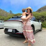 Freida Pinto Instagram - Let’s title this one trying to take a photo with your baby — they don’t sit still. Thank you @kiausa for letting us try out your fabulous EV6 over Monterey Car Week! Carmel by the Sea
