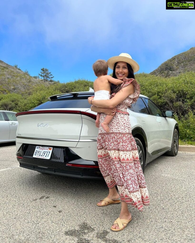 Freida Pinto Instagram - Let’s title this one trying to take a photo with your baby — they don’t sit still. Thank you @kiausa for letting us try out your fabulous EV6 over Monterey Car Week! Carmel by the Sea
