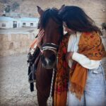 Iswarya Menon Instagram – The first time I ever spoke to a horse 🥺❤️
Do you believe in animal communication? I do!
I do that with @coffeemenon every single time 🥺
They understand every emotion, every thought of yours, you can talk to them telepathically.
One such experience was with this horse 🥺❤️
.
In Petra, jordan. My shoes broke on the way , it was a long way back to my hotel .. and the pathway was full of rocks, so it was impossible for me to walk barefoot back to the hotel .
I happened to ride on this particular horse ..
He kept halting on the way, showing his disinterest in walking. He kept nodding his head to his owner and refused to move!
I got down , requested him to help me, explained my situation, spoke to him eye to eye , gave him a hug 🥺
& on my request he walked without halting all the way for me 😞❤️ 
This blew my mind!
Are we human beings as empathetic as they are ?