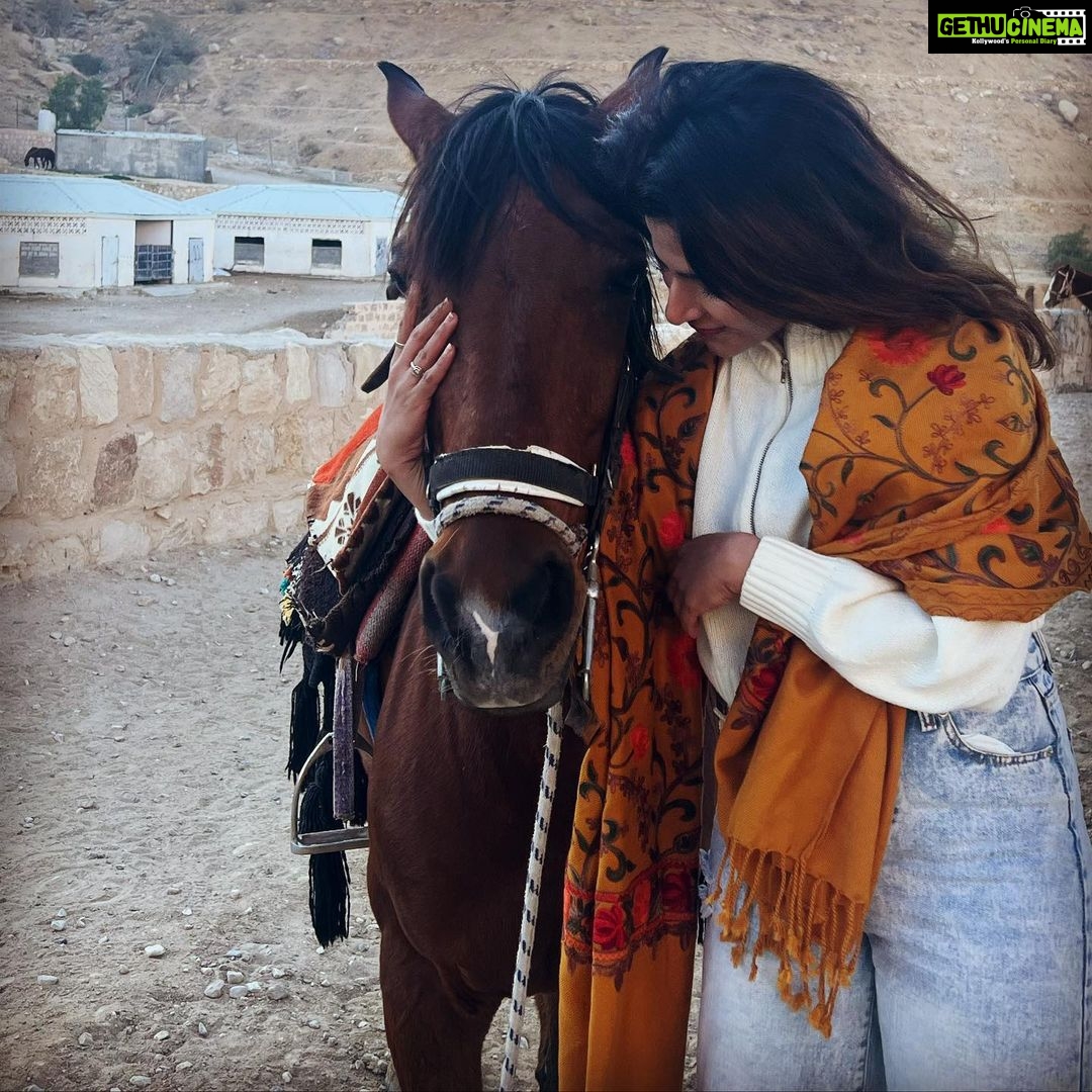 Iswarya Menon Instagram - The first time I ever spoke to a horse 🥺❤️ Do you believe in animal communication? I do! I do that with @coffeemenon every single time 🥺 They understand every emotion, every thought of yours, you can talk to them telepathically. One such experience was with this horse 🥺❤️ . In Petra, jordan. My shoes broke on the way , it was a long way back to my hotel .. and the pathway was full of rocks, so it was impossible for me to walk barefoot back to the hotel . I happened to ride on this particular horse .. He kept halting on the way, showing his disinterest in walking. He kept nodding his head to his owner and refused to move! I got down , requested him to help me, explained my situation, spoke to him eye to eye , gave him a hug 🥺 & on my request he walked without halting all the way for me 😞❤️ This blew my mind! Are we human beings as empathetic as they are ?