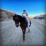 Iswarya Menon Instagram – The first time I ever spoke to a horse 🥺❤️
Do you believe in animal communication? I do!
I do that with @coffeemenon every single time 🥺
They understand every emotion, every thought of yours, you can talk to them telepathically.
One such experience was with this horse 🥺❤️
.
In Petra, jordan. My shoes broke on the way , it was a long way back to my hotel .. and the pathway was full of rocks, so it was impossible for me to walk barefoot back to the hotel .
I happened to ride on this particular horse ..
He kept halting on the way, showing his disinterest in walking. He kept nodding his head to his owner and refused to move!
I got down , requested him to help me, explained my situation, spoke to him eye to eye , gave him a hug 🥺
& on my request he walked without halting all the way for me 😞❤️ 
This blew my mind!
Are we human beings as empathetic as they are ?