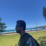 Abijeet Duddala Instagram - I'm doing something on the beach.. Taking the train day in and day out everyday like I did when I drove everyday to the mountains to learn to snowboard. What am I doing on the beach? Hint - I'm getting so tanned 😂 #beach #manly #PrimeReels #surf #straya Also this country has incredible sunsets! Manly Beach