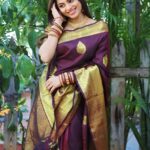 Delna Davis Instagram - Indulge in the luxurious elegance of our exclusive handwoven Kanchipuram silk saree, crafted with utmost precision and adorned with a resplendent gold zari woven border. This masterpiece of traditional artistry features a rich pallu that adds an opulent touch to its already exquisite design. The enchanting color of the saree is a captivating Dark Coffee Brown, exuding sophistication and grace. @prahlasilks . 📸 @shiva_anand_makeup_artist