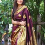 Delna Davis Instagram - Indulge in the luxurious elegance of our exclusive handwoven Kanchipuram silk saree, crafted with utmost precision and adorned with a resplendent gold zari woven border. This masterpiece of traditional artistry features a rich pallu that adds an opulent touch to its already exquisite design. The enchanting color of the saree is a captivating Dark Coffee Brown, exuding sophistication and grace. @prahlasilks . 📸 @shiva_anand_makeup_artist