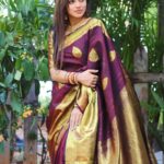 Delna Davis Instagram – Indulge in the luxurious elegance of our exclusive handwoven Kanchipuram silk saree, crafted with utmost precision and adorned with a resplendent gold zari woven border. This masterpiece of traditional artistry features a rich pallu that adds an opulent touch to its already exquisite design. The enchanting color of the saree is a captivating Dark Coffee Brown, exuding sophistication and grace. @prahlasilks 
.
📸 @shiva_anand_makeup_artist