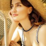 Elli AvrRam Instagram - Tell me about a place to Travel💙✨ Magazine: @culturedwedding Managing Editor: @yadav_manjeet Business Head: @divyanijain1925 Photographer: @nikhilshenoyphoto Outfit: @shopverb Hat: @myaraaindia Location: @theleelapalace_jaipur Co-ordinated by: @nadiiaamalik