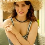 Elli AvrRam Instagram - Tell me about a place to Travel💙✨ Magazine: @culturedwedding Managing Editor: @yadav_manjeet Business Head: @divyanijain1925 Photographer: @nikhilshenoyphoto Outfit: @shopverb Hat: @myaraaindia Location: @theleelapalace_jaipur Co-ordinated by: @nadiiaamalik