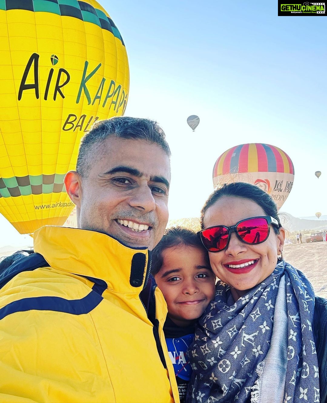 Gul Panag Instagram - Full of hot air. Literally. Our second time in Capadoccia. And just as magical. The hot air balloon ride is arguably one of the finest experiences that I’ve ever had. This time around, we had Nihal with us who was mesmerised. Seeing it all over again through his eyes, was an altogether different experience. Since we are here in the middle of summer, the days are very long , with sunrise at 5 AM. The balloon pilots typically take us up a little before so one can witness the sunrise in all its glory. Our pick up was at 3.45 AM. And Nihal was an absolute trooper. In fact, we woke up at 2.30 ( not unusual for Rishi, given his job💁🏻♀️,) cup of tea, when Nihal walked into the living room, rubbing his eyes. Hence, proved yet again, there are children will surprise us again and again. Like he did on the trek up to the Tigers’s nest in Bhutan are early this year. #travel #turkey #familytravel #travelgram Cappadocia