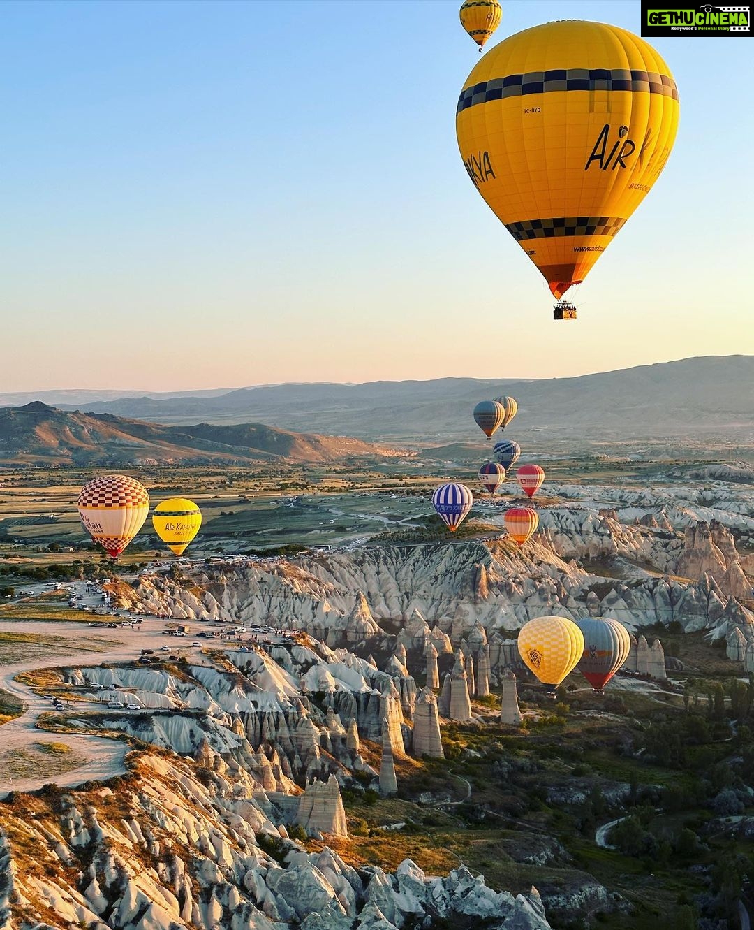 Gul Panag Instagram - Full of hot air. Literally. Our second time in Capadoccia. And just as magical. The hot air balloon ride is arguably one of the finest experiences that I’ve ever had. This time around, we had Nihal with us who was mesmerised. Seeing it all over again through his eyes, was an altogether different experience. Since we are here in the middle of summer, the days are very long , with sunrise at 5 AM. The balloon pilots typically take us up a little before so one can witness the sunrise in all its glory. Our pick up was at 3.45 AM. And Nihal was an absolute trooper. In fact, we woke up at 2.30 ( not unusual for Rishi, given his job💁🏻♀️,) cup of tea, when Nihal walked into the living room, rubbing his eyes. Hence, proved yet again, there are children will surprise us again and again. Like he did on the trek up to the Tigers’s nest in Bhutan are early this year. #travel #turkey #familytravel #travelgram Cappadocia