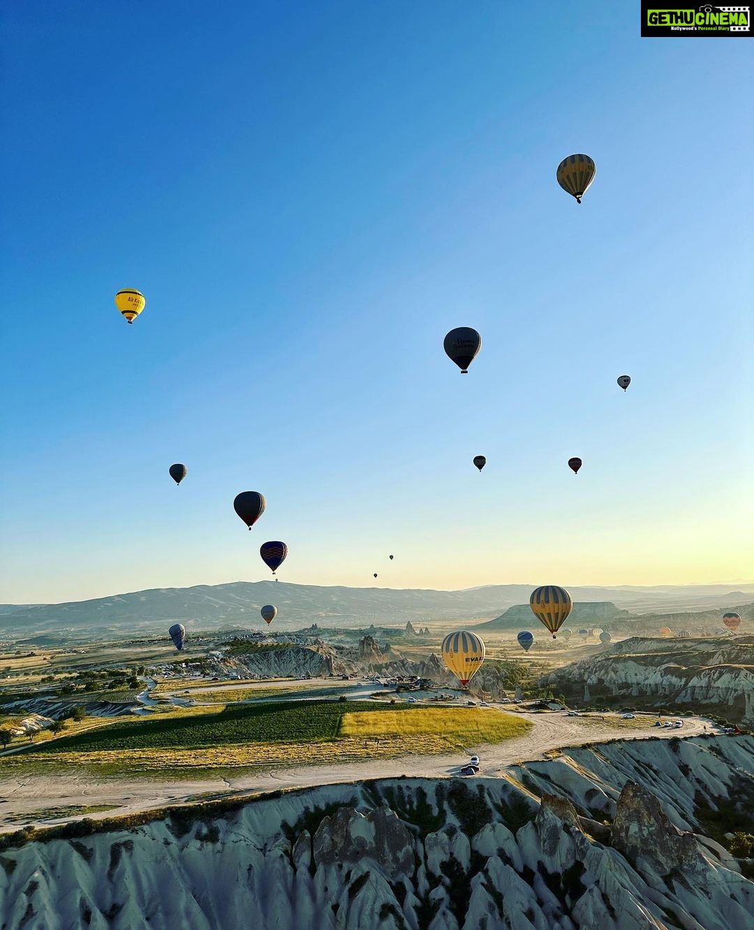 Gul Panag Instagram - Full of hot air. Literally. Our second time in Capadoccia. And just as magical. The hot air balloon ride is arguably one of the finest experiences that I’ve ever had. This time around, we had Nihal with us who was mesmerised. Seeing it all over again through his eyes, was an altogether different experience. Since we are here in the middle of summer, the days are very long , with sunrise at 5 AM. The balloon pilots typically take us up a little before so one can witness the sunrise in all its glory. Our pick up was at 3.45 AM. And Nihal was an absolute trooper. In fact, we woke up at 2.30 ( not unusual for Rishi, given his job💁🏻♀️,) cup of tea, when Nihal walked into the living room, rubbing his eyes. Hence, proved yet again, there are children will surprise us again and again. Like he did on the trek up to the Tigers’s nest in Bhutan are early this year. #travel #turkey #familytravel #travelgram Cappadocia