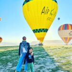 Gul Panag Instagram - Full of hot air. Literally. Our second time in Capadoccia. And just as magical. The hot air balloon ride is arguably one of the finest experiences that I’ve ever had. This time around, we had Nihal with us who was mesmerised. Seeing it all over again through his eyes, was an altogether different experience. Since we are here in the middle of summer, the days are very long , with sunrise at 5 AM. The balloon pilots typically take us up a little before so one can witness the sunrise in all its glory. Our pick up was at 3.45 AM. And Nihal was an absolute trooper. In fact, we woke up at 2.30 ( not unusual for Rishi, given his job💁🏻‍♀️,) cup of tea, when Nihal walked into the living room, rubbing his eyes. Hence, proved yet again, there are children will surprise us again and again. Like he did on the trek up to the Tigers’s nest in Bhutan are early this year. #travel #turkey #familytravel #travelgram Cappadocia