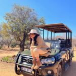 Harnaaz Kaur Sandhu Instagram - Do not try to fight a lion if you are not one yourself. @missuniverse @golden_impalas_bush_resort Styled by @meemmap Jacket vintage Top and pants @wightelephant Boots @dsw Makeup @reneedewitmakeupartist South Africa