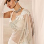Mouni Roy Instagram - My front row cliché 🤍 #ASareeGirlForever • • • Dressed in @rohitbalofficial Jewels @anmoljewellers Rings @narayanjewels Styled by @manekaharisinghani Hair by @hairbysharda Make up by @chettiaralbert Shot by @trishasarang